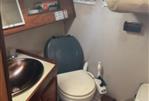 Jeanneau Attalia - Interior of 1983 Jeanneau Attalia sailboat bathroom with sink and toilet.