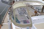 Bristol 35.5 - 1980 Bristol 35.5 sailboat cockpit with beige canvas cover and clear windows.