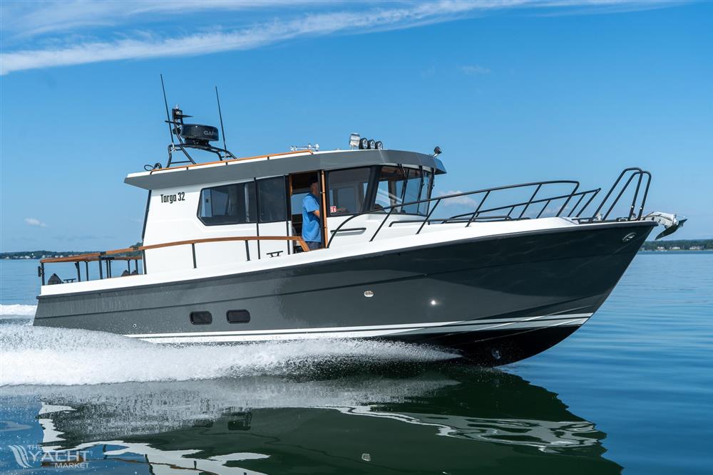Targa 32 - 2025 Targa 32 boat cruising on calm water under a clear blue sky.