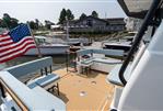 Targa 32 - 2025 Targa 32 boat deck with seating, American flag, and marina backdrop.