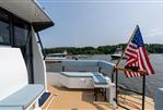 Targa 32 - 2025 Targa 32 boat deck with American flag, overlooking a serene lake.