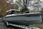 Axopar 28 CABIN - 2019 Axopar 28 CABIN boat on trailer, parked outdoors.