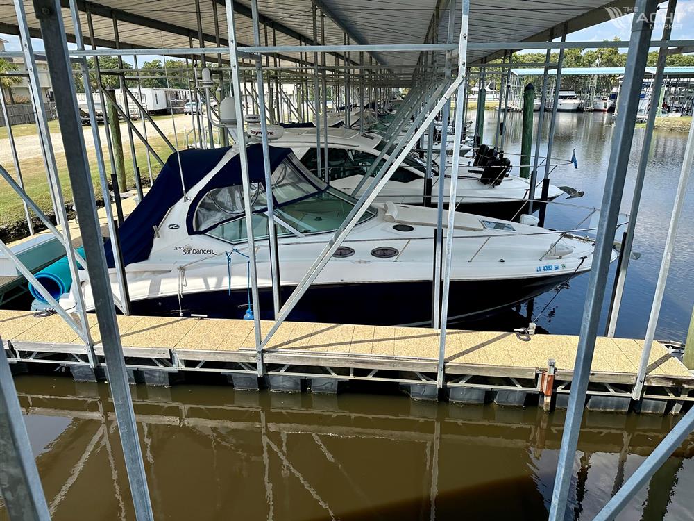Sea Ray 320 Sundancer - 2006 Sea Ray 320 Sundancer docked in a marina under a covered slip.