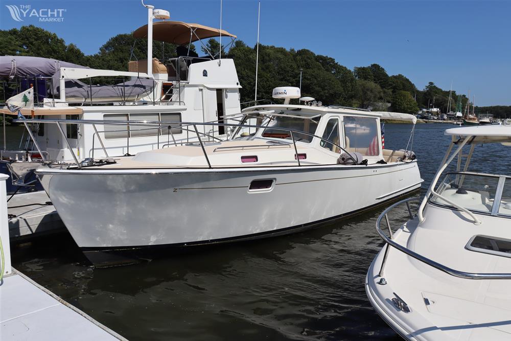 MJM 36z Downeast - 2013 MJM 36z Downeast boat docked in a marina, surrounded by other vessels.