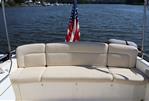 MJM 36z Downeast - 2013 MJM 36z Downeast boat with beige seating and American flag on a calm lake.