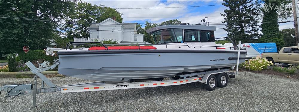 Axopar 28 - 2022 Axopar 28 boat on trailer, parked outdoors.