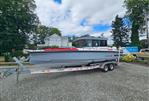 Axopar 28 - 2022 Axopar 28 boat on a trailer, parked outdoors on gravel.
