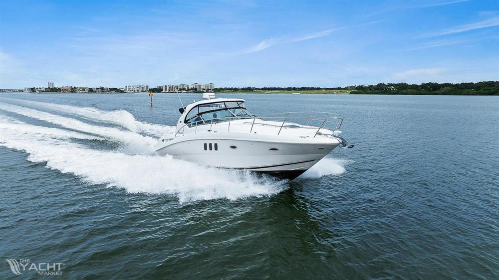 Sea Ray 38 Sundancer - 2006 Sea Ray 38 Sundancer cruising on open water under clear blue skies.