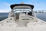 Sea Ray 38 Sundancer - 2006 Sea Ray 38 Sundancer yacht interior with seating and table, overlooking water and bridge.