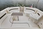 Sea Ray 38 Sundancer - 2006 Sea Ray 38 Sundancer boat deck with white seating and table on water.