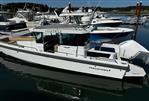 Axopar 28 CABIN - 2020 Axopar 28 CABIN boat docked in a marina, surrounded by other vessels.