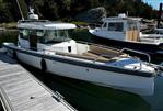 Axopar 28 CABIN - 2020 Axopar 28 CABIN boat docked in a serene marina setting.