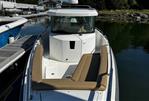 Axopar 28 CABIN - 2020 Axopar 28 CABIN boat docked, featuring sleek design and comfortable seating.