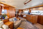 Bertram 670E - Luxurious interior of 2004 Bertram 670E yacht with elegant wood finishes and plush seating.