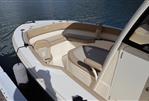 Scout 215 XSF - 2023 Scout 215 XSF boat interior with tan seating, docked by the water.