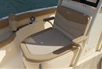 Scout 215 XSF - 2023 Scout 215 XSF boat seating area with beige upholstery and armrests.