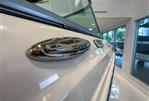Chaparral 23 SSi OB - 2024 Chaparral 23 SSi OB boat detail in showroom, showcasing sleek design and chrome accents.