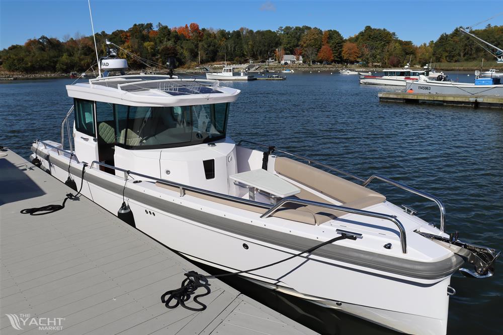 Axopar 28 CABIN - 2023 Axopar 28 CABIN boat docked on a scenic lake.