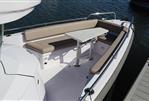 Axopar 28 CABIN - 2023 Axopar 28 CABIN boat with spacious seating and table on deck.