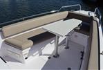 Axopar 28 CABIN - 2023 Axopar 28 CABIN boat with beige seating and white table on deck.