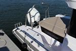Axopar 28 CABIN - 2023 Axopar 28 CABIN boat with outboard motor, docked on calm water.
