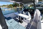 Axopar 37 Sun Top - 2022 Axopar 37 Sun Top boat interior with seating and helm, docked by waterfront homes.