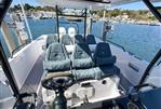 Axopar 37 Sun Top - 2022 Axopar 37 Sun Top boat interior with seating, steering wheel, and waterfront view.
