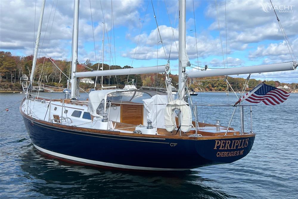 Hinckley Bermuda - 1967 Hinckley Bermuda sailboat on calm water, displaying American flag.