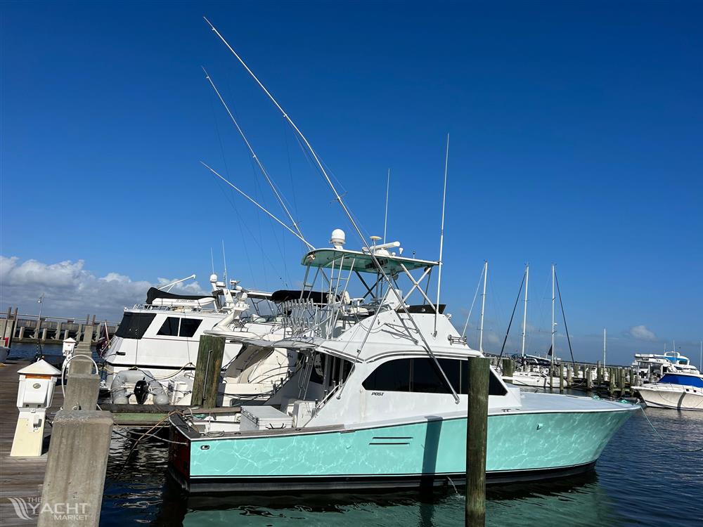 Post 43 - 1989 Post 43 yacht docked at marina under clear blue sky.