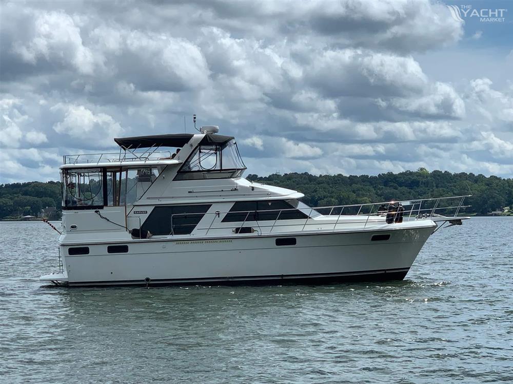 Carver 4207 - 1987 Carver 4207 yacht on a lake under cloudy skies.