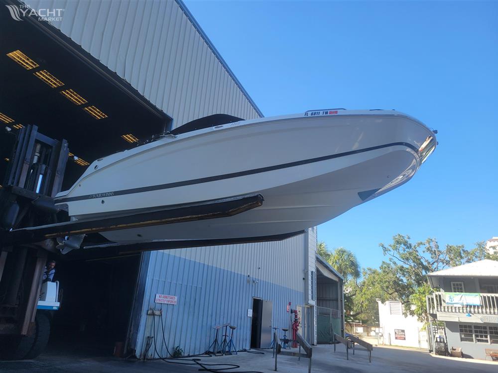 Four Winns HD3 - 2022 Four Winns HD3 boat being lifted outside a warehouse.