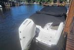 Four Winns HD3 - 2022 Four Winns HD3 boat docked with cover, featuring outboard motor.