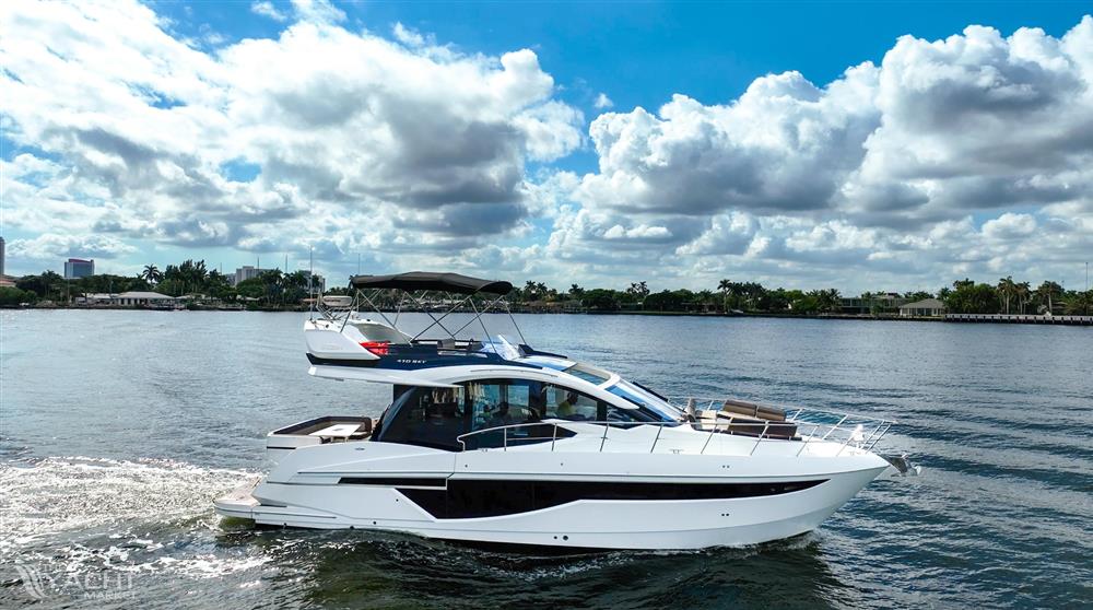 Galeon 47 Sky - 2022 Galeon 47 Sky yacht cruising on a sunny day with scenic water backdrop.