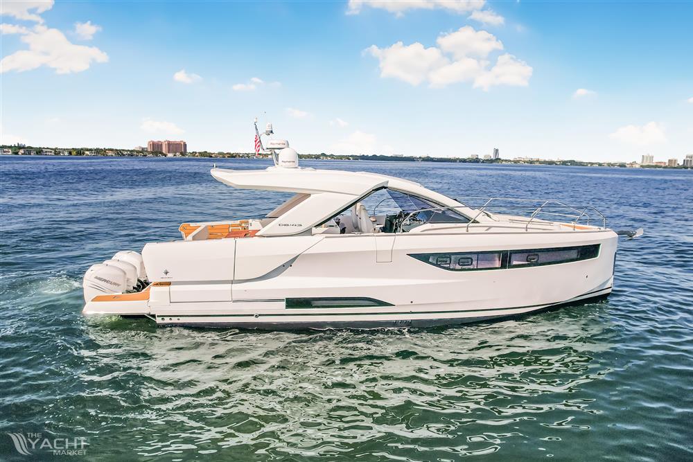 Jeanneau DB43 - 2023 Jeanneau DB43 yacht cruising on open water under a clear blue sky.