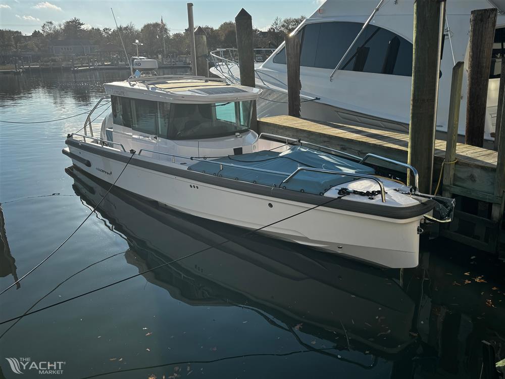 Axopar 28 CABIN - 2023 Axopar 28 CABIN boat docked in a serene marina setting.