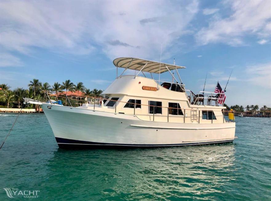 Monk 38 - 1978 Monk 38 yacht on turquoise water with palm trees in the background.