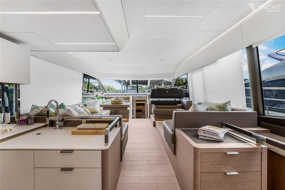 Prestige 590 flybridge - Luxurious interior of 2024 Prestige 590 flybridge yacht with modern kitchen and seating area.
