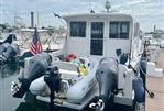 Wesmac 42 - 2016 Wesmac 42 boat docked with twin outboard motors and American flag.