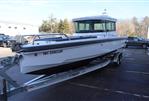 Axopar 28 CABIN - 2021 Axopar 28 CABIN boat on trailer in parking lot.