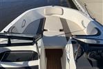 Bayliner VR4 - 2018 Bayliner VR4 boat interior with seating and dashboard, docked by the water.