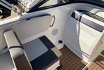 Bayliner VR4 - 2018 Bayliner VR4 boat interior with cushioned seating and wood-style flooring.