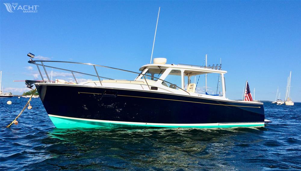 MJM 29z Downeast - 2007 MJM 29z Downeast boat on water, clear blue sky, American flag displayed.