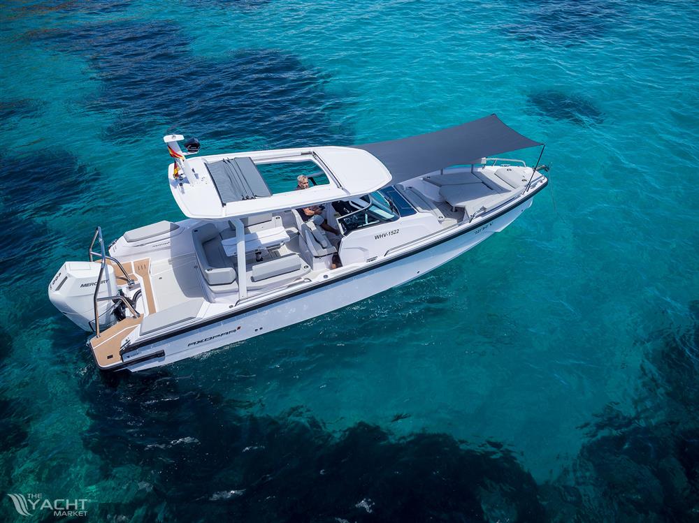 Axopar 29 Suntop - 2025 Axopar 29 Suntop boat on clear blue water, featuring sleek design and sunshade.