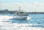 Axopar 29 Suntop - 2025 Axopar 29 Suntop cruising on open water, scenic coastal background.