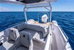 Axopar 29 Suntop - 2025 Axopar 29 Suntop boat interior with ocean view, featuring modern seating and outboard motor.