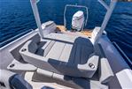 Axopar 29 Suntop - 2025 Axopar 29 Suntop boat with spacious seating and outboard motor on calm water.