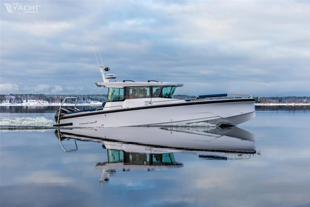 Axopar 29 Cross Cabin - 2025 Axopar 29 Cross Cabin boat cruising on calm water under cloudy skies.