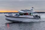 Axopar 29 Cross Cabin - 2025 Axopar 29 Cross Cabin boat cruising on water at sunset.