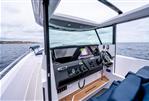 Axopar 29 Cross Cabin - 2025 Axopar 29 Cross Cabin interior with modern dashboard and steering, overlooking the ocean.