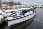 Axopar 29 Cross Cabin - 2025 Axopar 29 Cross Cabin boat docked in snowy waterside setting.